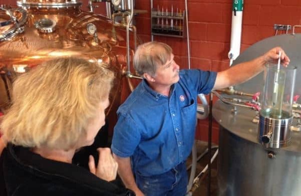 Pete Kamer, distilling instructor at Moonshine University, demonstrates how to use a hydrometer. Photo by Stephen Coomes. 