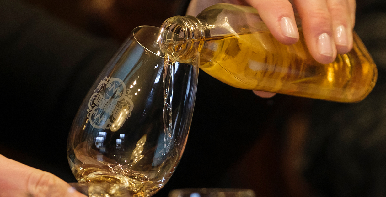 Whisky being poured into an SMWS tasting glass ready for the tasting panel to assess. 