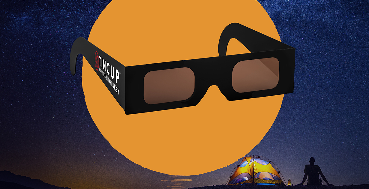 A pair of limited edition TINCUP Whiskey solar eclipse glasses. 